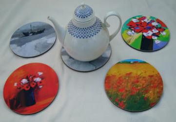 5 circular pot stands, one holding a teapot